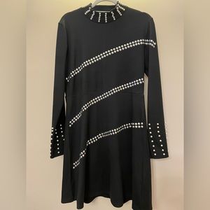 A classic black dress with pearls designs.